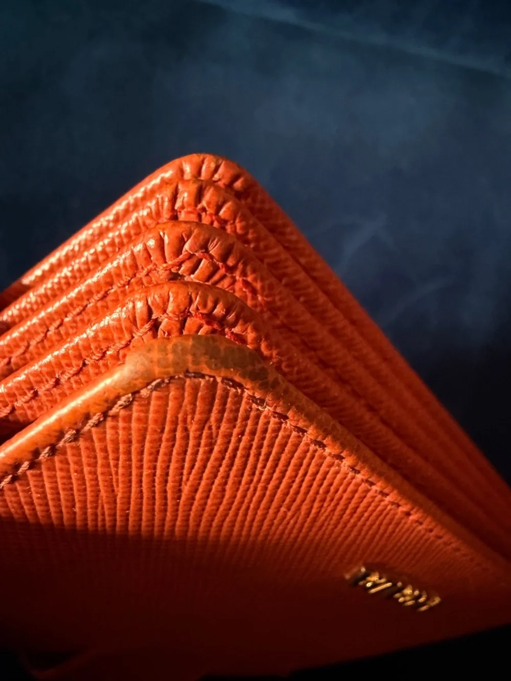 Orange Prada Saffiano Leather accordion card holder.